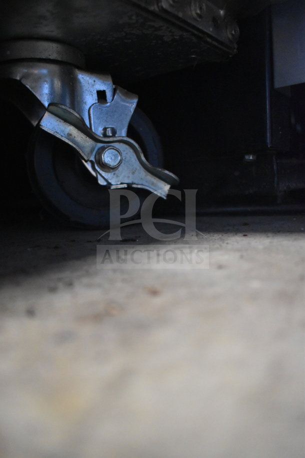 Turbo Air M3F24-1-N freezer caster wheel, showing sturdy metal construction, part of reach-in freezer design.