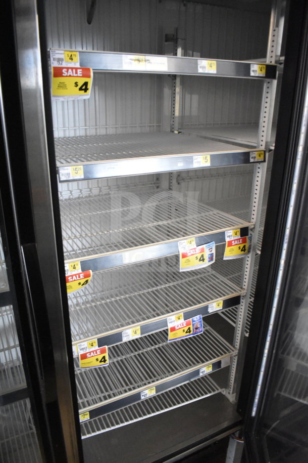 2019 True GDM-472F-HC commercial 3-door freezer; tested, working; shelves, sale tags visible; 115/208-230V, 1 phase.