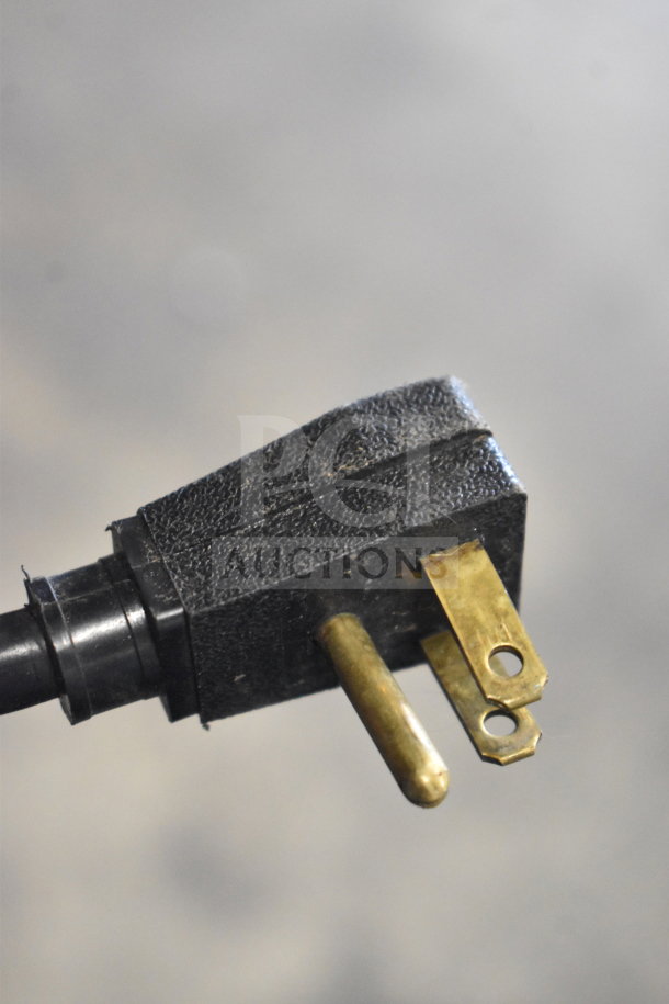 Close-up of a three-prong plug for the True GDM-472F-HC commercial freezer, model T-23F, tested and working.