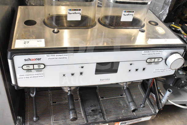 Schaerer Barista commercial countertop 2-group espresso machine with two hoppers, two portafilters, and labeling instructions.