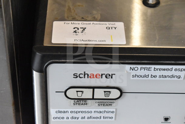 Schaerer Barista commercial espresso machine panel with latte and cappuccino steam buttons, showing brand and cleanliness instructions.