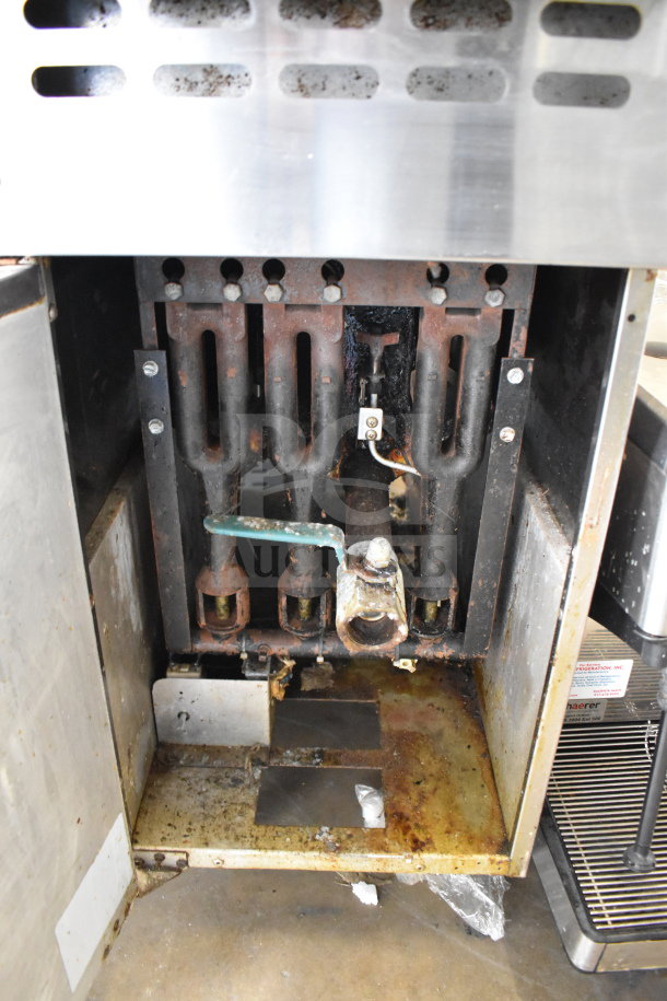 Bakers Pride commercial natural gas deep fat fryer, 114,000 BTU, internal view showing gas lines and burner condition.