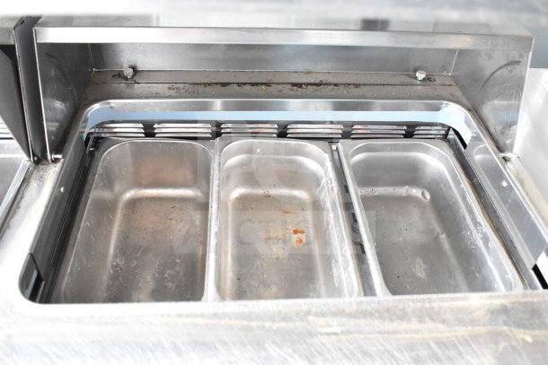 2017 Delfield UCD4464N-12-DD5 sandwich prep table in fair condition, showing stainless steel bain marie pans.