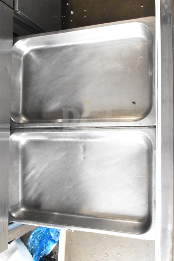 2017 Delfield UCD4464N-12-DD5 sandwich prep table drawer interior in stainless steel, showing dual compartments.
