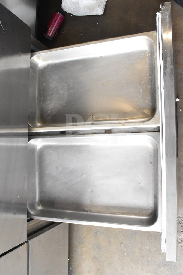 2017 Delfield UCD4464N-12-DD5 commercial prep table with stainless steel drawers, showing interior condition.