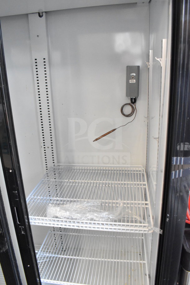 Bison SGM-35 Commercial 2 Door Reach In Cooler Merchandiser, 115V, features wire shelves, in good condition.