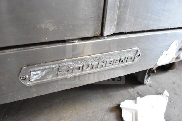 Southbend commercial flat top griddle with convection oven on casters, featuring a stainless steel exterior and visible brand label.