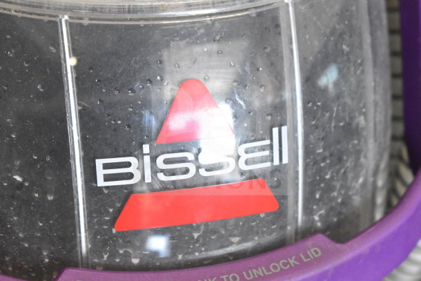 Bissell 2458 SpotClean PetPro vacuum cleaner, clear tank with red logo, purple accents, 115 volts, for pet stains.