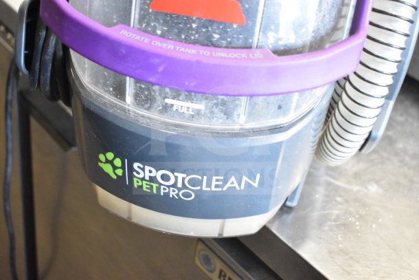 Bissell 2458 SpotClean PetPro Vacuum Cleaner, shown in good condition, features visible labels and purple carrying handle.
