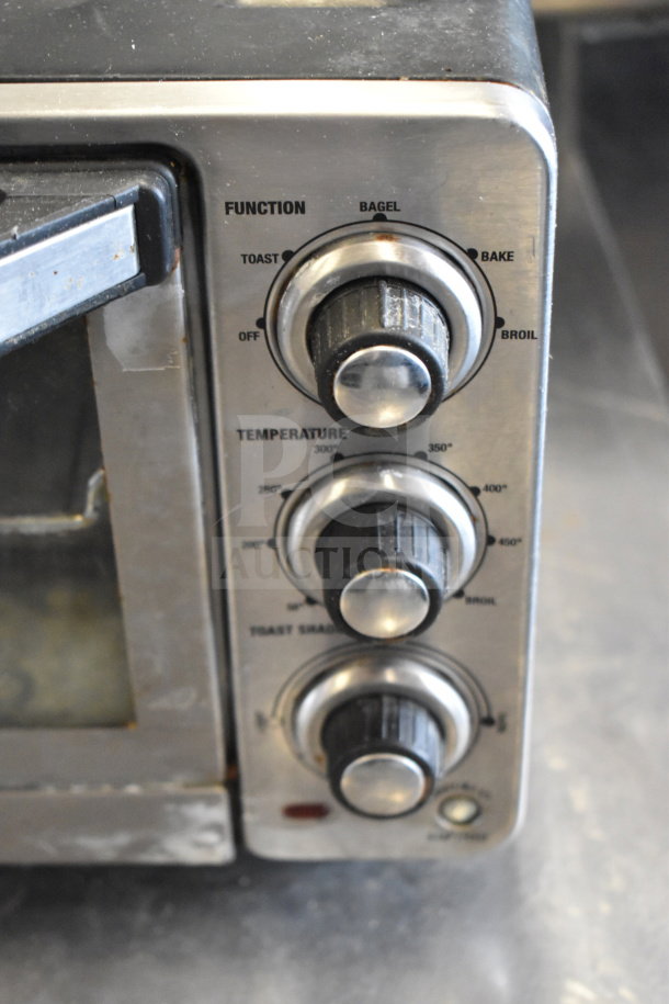 Cuisinart TOB-40 Countertop Toaster Oven with function and temperature dials, visible wear on stainless steel panel.