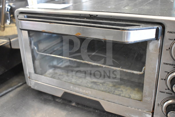 Cuisinart TOB-40 countertop toaster oven, visible wear, stainless steel exterior, adjustable controls, 120 volts, 1 phase.