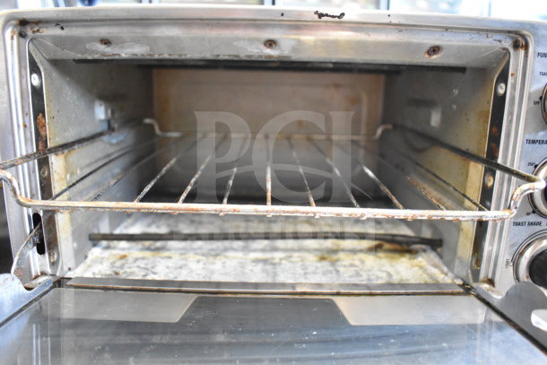 Cuisinart TOB-40 countertop toaster oven, 120V, showing interior with rack. Used condition, some discoloration and wear visible.