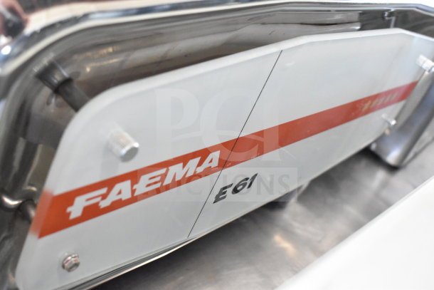 Faema E61 commercial espresso machine with "Faema E61" branding. Includes 2 portafilters, steam wand. Appears in good condition.
