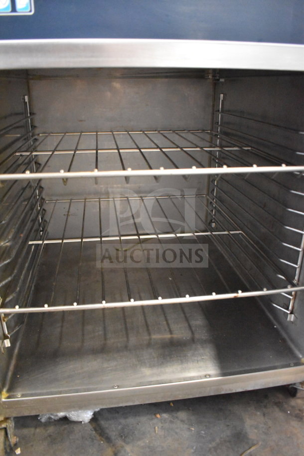 Alto Shaam 750-S heated holding cabinet, stainless steel interior, on commercial casters, 120V, 1 phase, shows two wire racks.