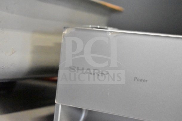 Sharp undercounter dishwasher, 115 volts, 1 phase. Visible branding. Slight wear on edges. Suitable for compact spaces.