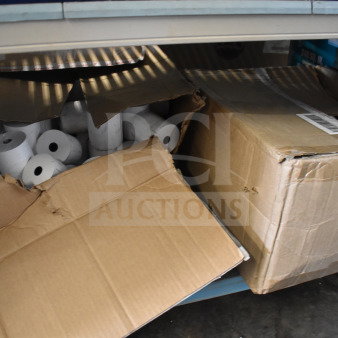 Boxes of receipt printer rolls, partially opened, showing multiple rolls inside. Rolls in original packaging.