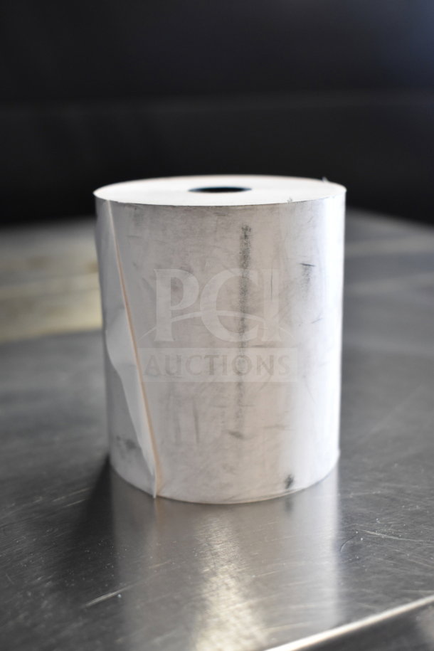 Receipt printer roll, new in original box, showing outer paper condition with some scuff marks.