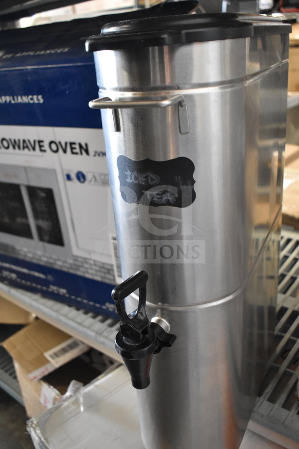 Grindmaster 6700-30000 beverage dispenser, stainless steel, labeled "Iced Tea," in good condition with spigot and handles.