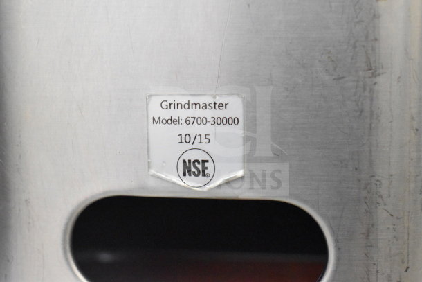 Grindmaster 6700-30000 beverage holder and dispenser, stainless steel, model label visible with NSF certification, used condition.