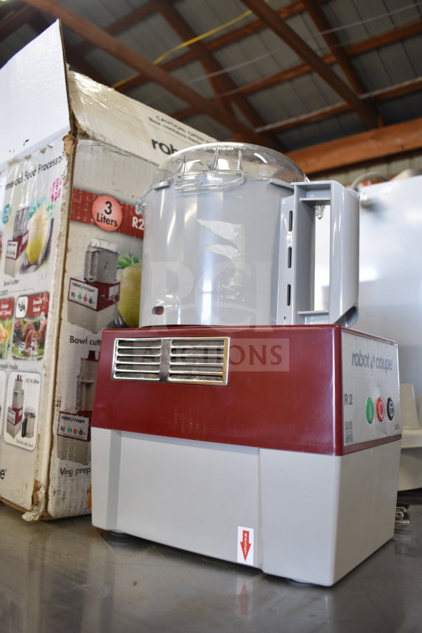 Robot Coupe R2 Commercial Food Processor with blades, used condition, red and gray housing, visible control buttons.