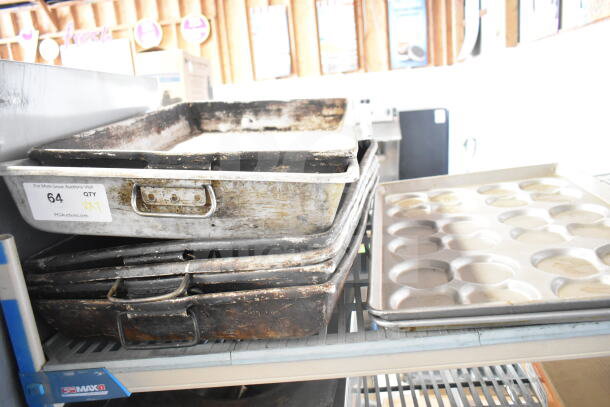 Seven assorted baking items including metal roasting pans and two bun baking pans, in used condition, with auction label.