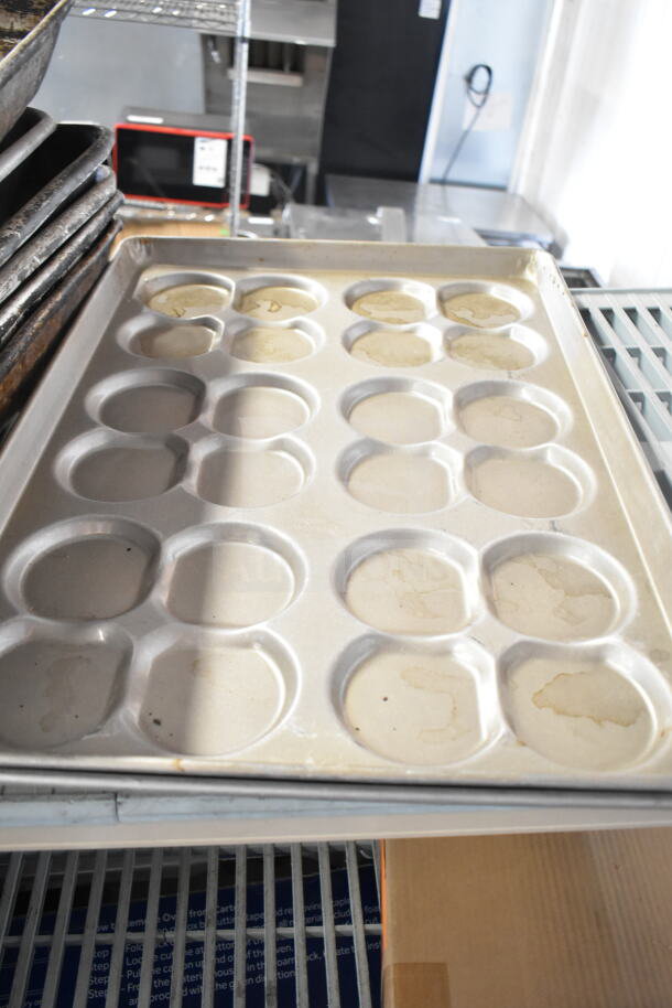 Metal bun baking pan, slightly used, with multiple slots for baking. Part of a 7-item set including roasting pans.