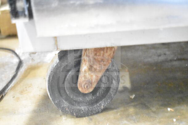 Beverage Air ER48-1AS cooler's commercial caster showing signs of wear.