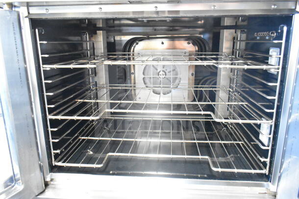 Vulcan commercial electric convection oven with view-through doors, thermostatic controls, and metal legs, pristine interior.