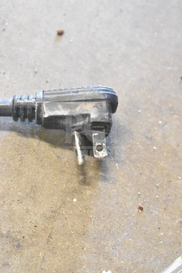 Power plug of Universal Nolin MC1100S-1 commercial cooler, 115 volts, shows wear, key component for functionality.