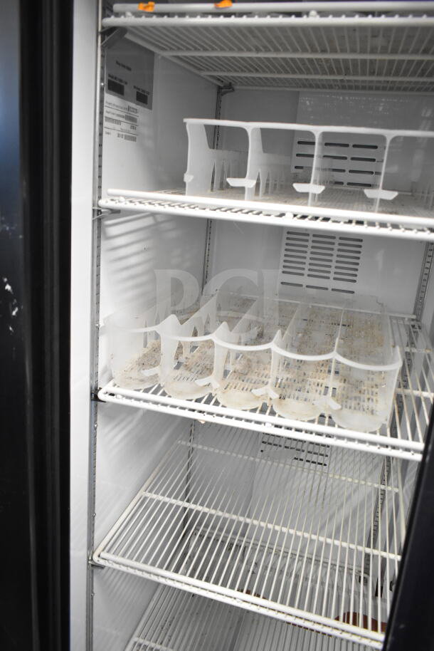 Universal Nolin MC1100S-1 commercial 2-door cooler merchandiser, shelves shown. Model, serial labels visible. 115V, 1 phase.