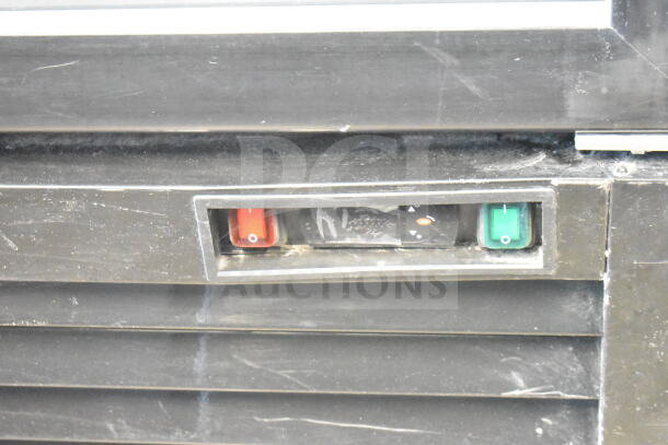 2020 MCF8724GR Commercial 3 Door Reach-In Cooler Merchandiser controls. Shows red and green switches.