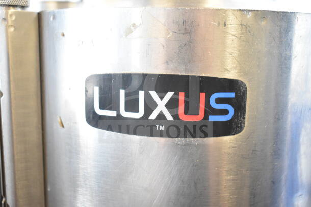 2 Fetco TPD-15 Luxus beverage dispensers, stainless steel, visible Luxus branding, with minor surface wear.