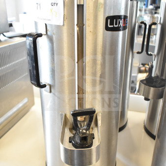 2 Fetco TPD-15 Luxus beverage dispensers, stainless steel, visible Luxus logo, includes handles and spouts, used condition.