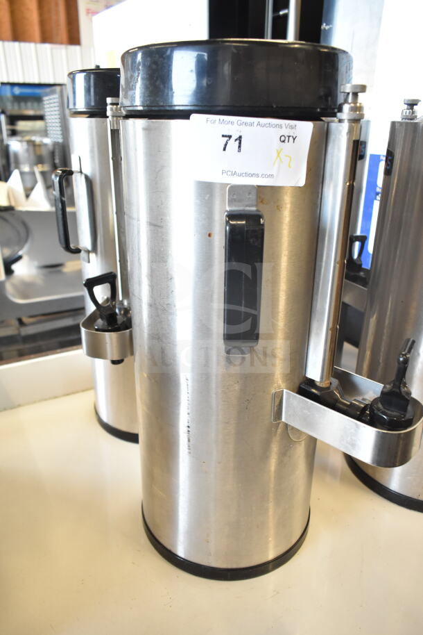 Two Fetco TPD-15 Luxus beverage holders, stainless steel, with handles and spouts. Auction tag reads "71." Good condition.