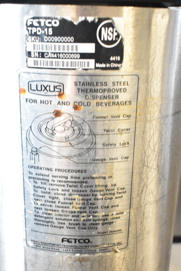 Fetco TPD-15 Luxus Beverage Dispenser. Stainless steel, suitable for hot/cold beverages. Includes operational instructions.