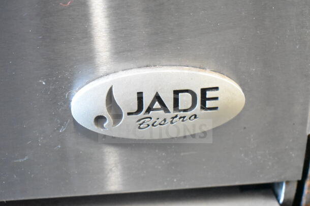 Jade Bistro commercial gas range with oven, 4 burners, stainless steel, logo plaque visible. Ideal for heavy-duty use.