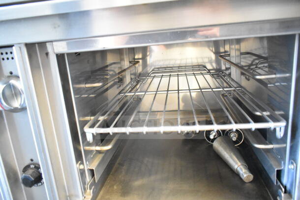 Jade Bistro commercial gas range, 4 burners, with oven, stainless steel interior, control knobs visible, excellent condition.