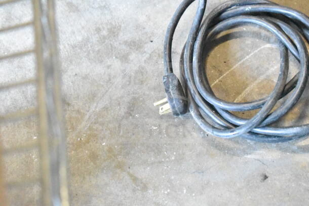 Coiled power cord of an Imbera VFD43 Commercial 2 Door Freezer Merchandiser, 115 Volts, 1 Phase.