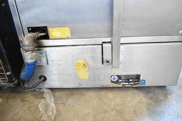 DG16V natural gas gyro machine with visible wear. Labels indicate gas type and safety certifications.