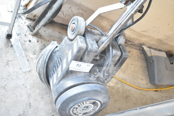 Powr-Flite P131-3 floor cleaning machine, shows signs of use, visible logo and model label, sturdy design.