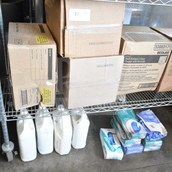 Two-tier rack with boxes of 3-in-1 multi-use cleaner, Concrobium disinfectant bottles, and blue nitrile gloves. Labels visible.