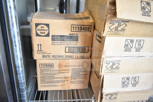 Boxes of Non-Corrosive Lime Scale Remover stacked on metal shelf, packaging shows 99 supply use, and safety warnings.