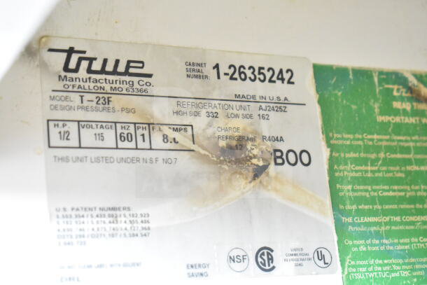 True T-23F freezer label showing model, voltage 115V, 1 phase, and design specifics. Serial 1-2635242 visible.