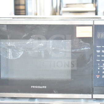 Frigidaire EMW1510 countertop microwave oven, black and stainless steel, 120 volts, 1 phase, visible wear on door.