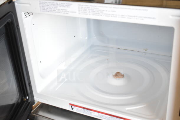 Frigidaire EMW1510 Countertop Microwave Oven, 120 Volts, open door view, white interior; appears in good condition.