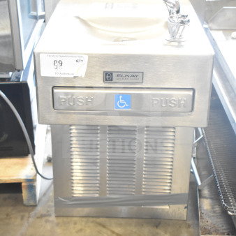 Elkay wall mount water fountain, stainless steel, used condition. Features Flexi-Guard bubbler, wheelchair accessible push pads.