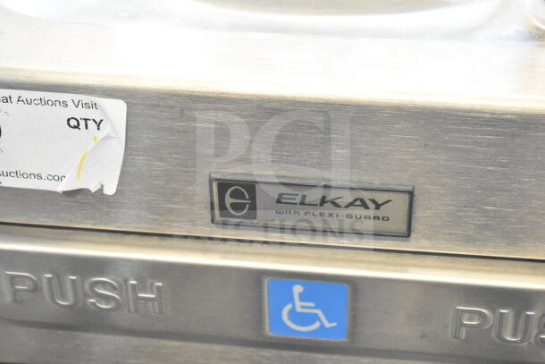 Elkay Wall Mount Water Fountain with Flexi-Guard, stainless steel, features push button, ADA compliant symbol.
