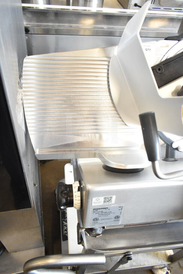 Bizerba GSP V meat slicer on Face to Face stand, 120V, 1 phase, metal finish, adjustment knob, visible brand label.