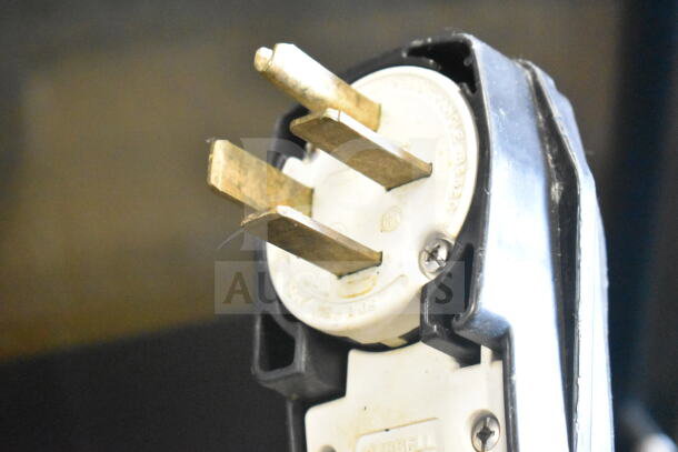 Fri-jado TDR 7-P plug, three prong, designed for 208V, 3-phase electric connection. Close-up of prongs and plug casing.