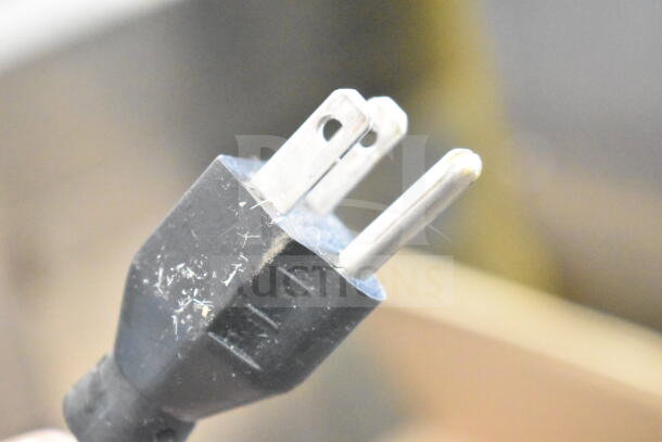 Close-up of a power plug for a 2017 Hobart HTi-LH26 commercial food portioning scale, showing minimal wear.